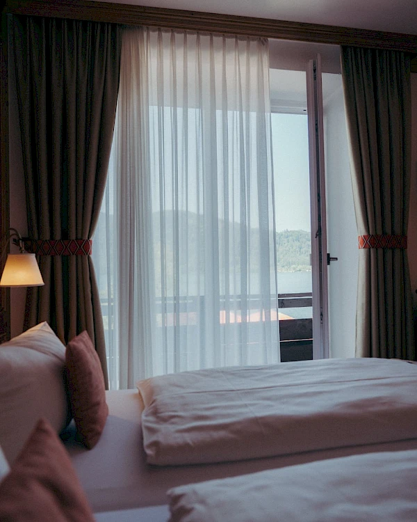 Cosy room with open window and lake view.