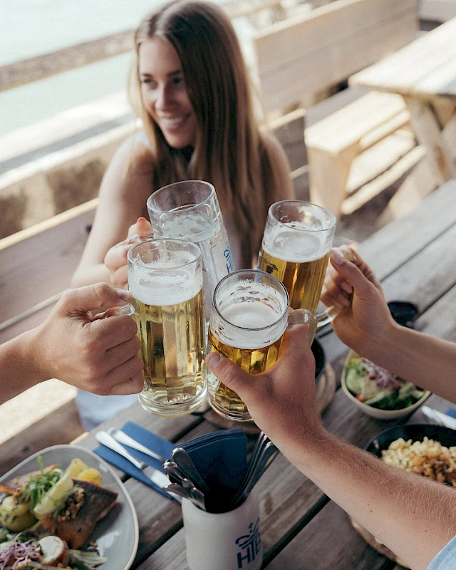 Friends toast each other over hearty food and beer in the beer garden.