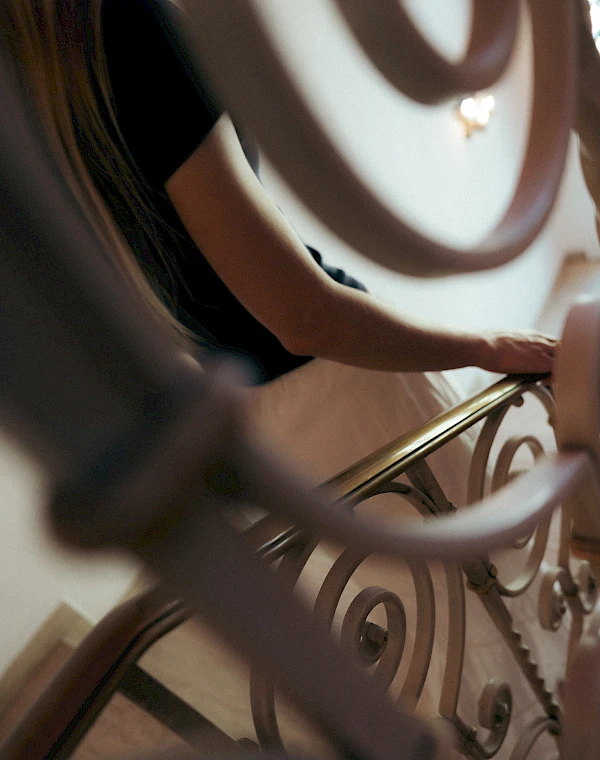 Woman in a beautiful old stairwell