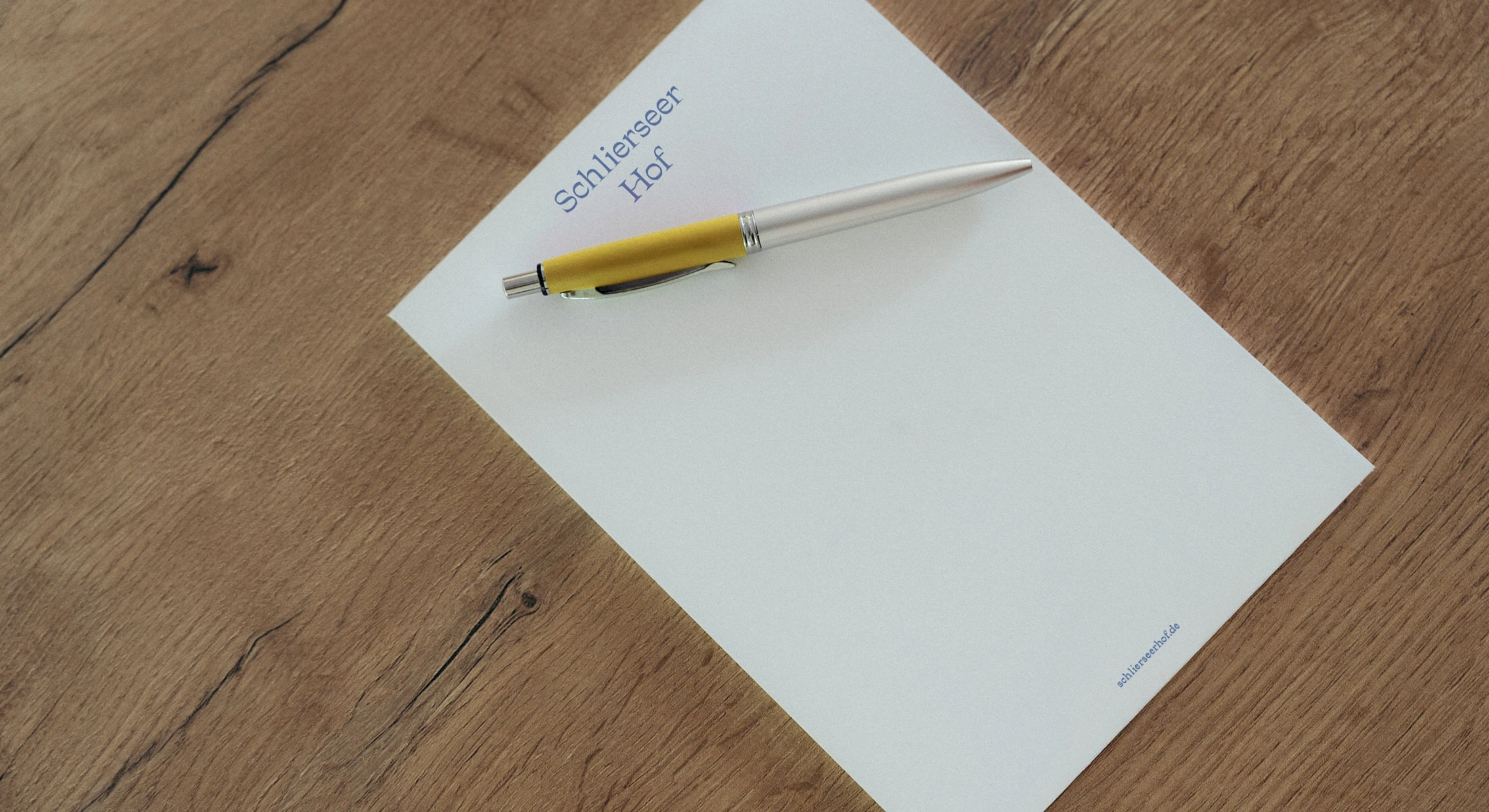 Notepad with Schlierseer Hof logo and pen