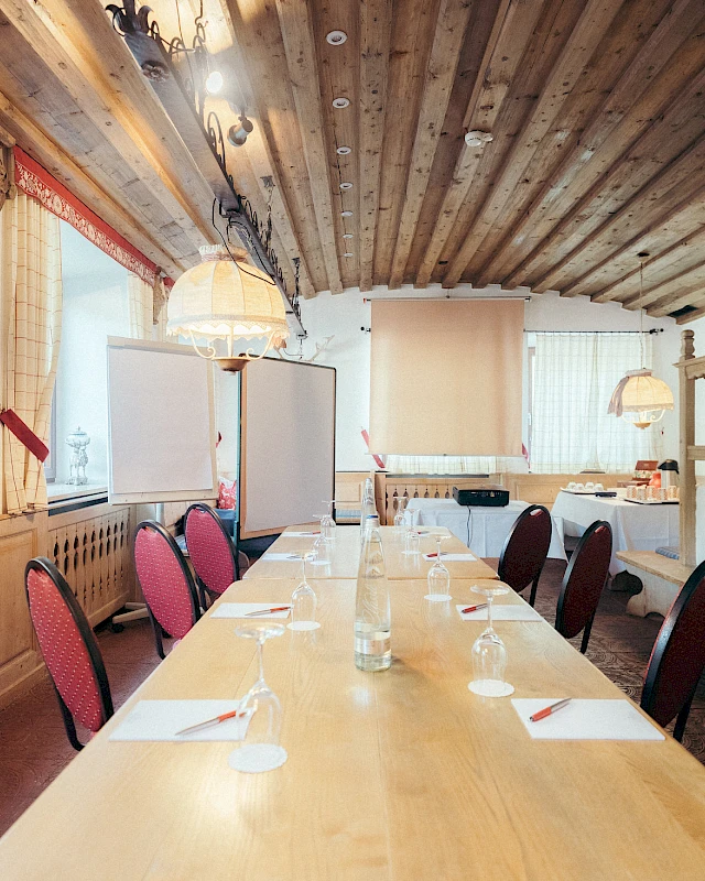 Conference room with modern equipment and rustic tiled stove